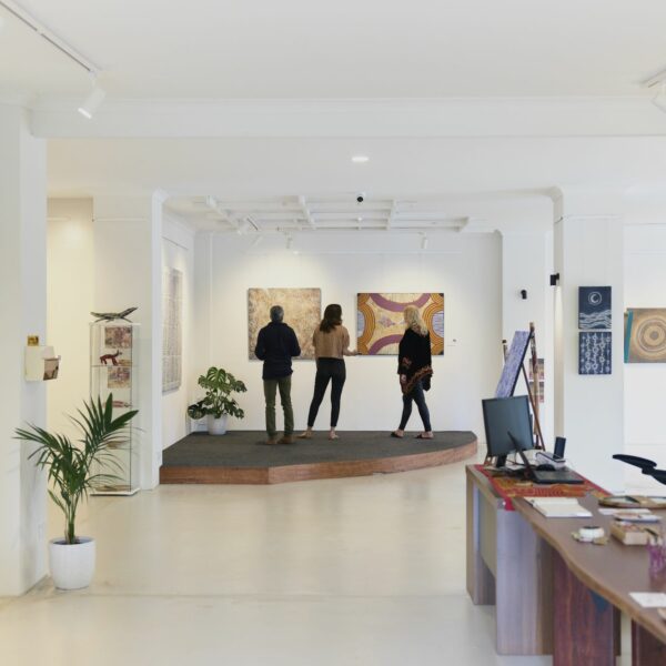 People standing in our art gallery Yallingup Aboriginal Art, looking at fine Indigenous art.