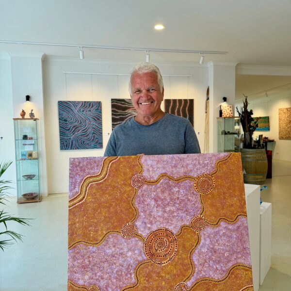 John Sara holding his artwork